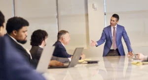 Shapiro standing at head of board table
